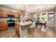 Open kitchen flows to the dining area with island, stainless steel appliances, and backyard views at 2418 W Jake Hvn, Phoenix, AZ 85085