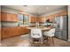Bright kitchen with stainless appliances, barstool seating at island, and ample cabinet storage at 2418 W Jake Hvn, Phoenix, AZ 85085