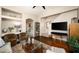 Cozy living room features hardwood floors, stylish furnishings, a large TV, and staircase access at 2418 W Jake Hvn, Phoenix, AZ 85085