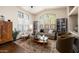 Bright living room with high ceilings, large windows, hardwood floors, and modern furniture at 2418 W Jake Hvn, Phoenix, AZ 85085