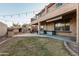This backyard has a covered patio, a fireplace, and an upper level balcony overlooking the yard at 26529 N 167Th Ave, Surprise, AZ 85387