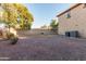 This backyard has gravel landscaping, some trees, and is enclosed by a block wall at 26529 N 167Th Ave, Surprise, AZ 85387