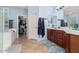 Bathroom with a double vanity, walk-in closet, bathtub and ceramic tile flooring at 26529 N 167Th Ave, Surprise, AZ 85387