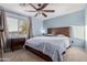 Bedroom featuring neutral walls, dark furniture, a ceiling fan, and a large window for ample natural light at 26529 N 167Th Ave, Surprise, AZ 85387