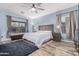Bedroom featuring neutral walls, hardwood floors, a ceiling fan, and a large window for ample natural light at 26529 N 167Th Ave, Surprise, AZ 85387
