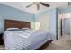 Cozy bedroom with blue walls, a ceiling fan, and soft carpet flooring at 26529 N 167Th Ave, Surprise, AZ 85387