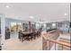 Spacious dining and living area featuring an expansive dining table and multiple windows showcasing outdoor views at 26529 N 167Th Ave, Surprise, AZ 85387