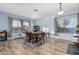 Bright dining room with wood floors, large windows, and a classic chandelier, perfect for Gathering gatherings at 26529 N 167Th Ave, Surprise, AZ 85387