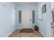 Inviting entryway with light blue walls, tile floors, and a white front door, creating a welcoming space at 26529 N 167Th Ave, Surprise, AZ 85387