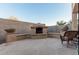 This outdoor fireplace has seating and is landscaped with potted desert plants at 26529 N 167Th Ave, Surprise, AZ 85387