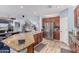 Open-concept kitchen with a large island, stainless steel refrigerator, and direct view of the staircase at 26529 N 167Th Ave, Surprise, AZ 85387
