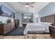 This is a beautifully decorated primary bedroom with wood accents, a large window, and plush carpet at 26529 N 167Th Ave, Surprise, AZ 85387