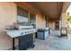 This patio has a grill, a window to the interior, and plenty of space for outdoor dining at 26529 N 167Th Ave, Surprise, AZ 85387