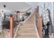Carpeted staircase with wooden railing, leading to an upper level, showcasing the home's interior design at 26529 N 167Th Ave, Surprise, AZ 85387