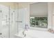 Bright bathroom featuring a soaking tub, separate shower, and large window with natural light at 2989 N 44Th St # 3044, Phoenix, AZ 85018