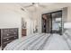 Light-filled bedroom with ceiling fan, dresser, and sliding doors to a balcony at 2989 N 44Th St # 3044, Phoenix, AZ 85018