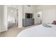 Bright bedroom featuring a dresser with TV, plush carpet, and an ensuite bathroom at 2989 N 44Th St # 3044, Phoenix, AZ 85018