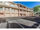 Exterior view of the condos featuring multiple garages, balconies, and a well-maintained parking lot in front at 2989 N 44Th St # 3044, Phoenix, AZ 85018