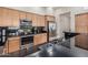 This well-equipped kitchen features a large stainless steel refrigerator and granite counter tops at 2989 N 44Th St # 3044, Phoenix, AZ 85018