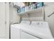 Well-equipped laundry room with washer and dryer, featuring storage shelves for detergents and laundry essentials at 2989 N 44Th St # 3044, Phoenix, AZ 85018
