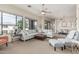 Expansive living room featuring a plush sectional sofa, leather ottoman, and sun-filled windows at 2989 N 44Th St # 3044, Phoenix, AZ 85018