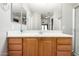 Bathroom featuring wood cabinets, large mirror, shower and new flooring at 3020 E Megan St, Gilbert, AZ 85295