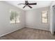 Carpeted bedroom with ceiling fan and natural light. Offers a serene atmosphere for relaxation at 3020 E Megan St, Gilbert, AZ 85295