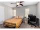 Bedroom with ceiling fan, desk, and bright natural light. Perfect for comfort and productivity at 3020 E Megan St, Gilbert, AZ 85295