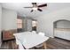 Dining room with natural light, wood-look flooring, ceiling fan, and a modern white table at 3020 E Megan St, Gilbert, AZ 85295