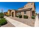 Charming stucco house featuring low-maintenance landscaping and a welcoming arched entryway at 3020 E Megan St, Gilbert, AZ 85295