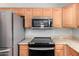 Kitchen featuring modern appliances, granite counters, and wood cabinets at 3020 E Megan St, Gilbert, AZ 85295