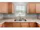 Kitchen featuring double basin sink, granite countertops, and wood cabinets at 3020 E Megan St, Gilbert, AZ 85295