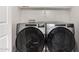 Convenient laundry area featuring modern side-by-side washer and dryer units, with storage shelves at 3020 E Megan St, Gilbert, AZ 85295