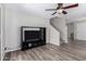 Open living room featuring wood floors, ceiling fan and entertainment center with TV at 3020 E Megan St, Gilbert, AZ 85295