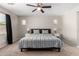 Main bedroom features neutral carpet, ceiling fan, and dual bedside tables with lamps at 3020 E Megan St, Gilbert, AZ 85295