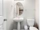 Powder room with pedestal sink and oval mirror at 3020 E Megan St, Gilbert, AZ 85295