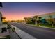 Balcony overlooking a busy street with modern buildings and palm trees under a colorful sky at 340 E Osborn Rd # 1, Phoenix, AZ 85012