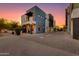 Striking modern home showcasing a private balcony and spacious driveway under a vivid sunset sky at 340 E Osborn Rd # 1, Phoenix, AZ 85012