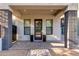 Charming front porch featuring contemporary door, side windows, and potted plants for added curb appeal at 340 E Osborn Rd # 1, Phoenix, AZ 85012