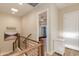 Bright hallway featuring wood stairs, stylish decor, and a peek into a serene bedroom at 340 E Osborn Rd # 1, Phoenix, AZ 85012