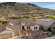View of a single-Gathering home showcasing a three-car garage, tile roof, and desert landscaping at 3551 W Hidden Mountain Ln, Anthem, AZ 85086