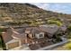 A birds eye view of a house showcasing its desert surroundings, and well-maintained yard at 3551 W Hidden Mountain Ln, Anthem, AZ 85086