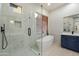 Bathroom featuring a glass-enclosed shower, freestanding tub, and vanity with granite countertops at 3551 W Hidden Mountain Ln, Anthem, AZ 85086
