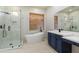 Modern bathroom with a walk-in shower, soaking tub, and a vanity with double sinks and white countertops at 3551 W Hidden Mountain Ln, Anthem, AZ 85086