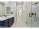 Bright bathroom featuring a walk-in shower, double vanity with modern fixtures, and spacious layout at 3551 W Hidden Mountain Ln, Anthem, AZ 85086