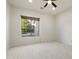 Bedroom with neutral walls, tile flooring, a ceiling fan, and a window with wood blinds at 3551 W Hidden Mountain Ln, Anthem, AZ 85086