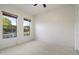 Spacious bedroom with tile flooring, two windows with blinds, and a ceiling fan at 3551 W Hidden Mountain Ln, Anthem, AZ 85086
