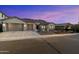 Charming single-story home featuring a three-car garage, desert landscaping, and a welcoming facade at 3551 W Hidden Mountain Ln, Anthem, AZ 85086