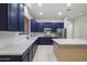 Stylish kitchen featuring blue cabinets, white countertops, and modern stainless steel appliances at 3551 W Hidden Mountain Ln, Anthem, AZ 85086