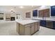 Bright, open kitchen with large island, stainless steel appliances, and elegant blue cabinetry at 3551 W Hidden Mountain Ln, Anthem, AZ 85086